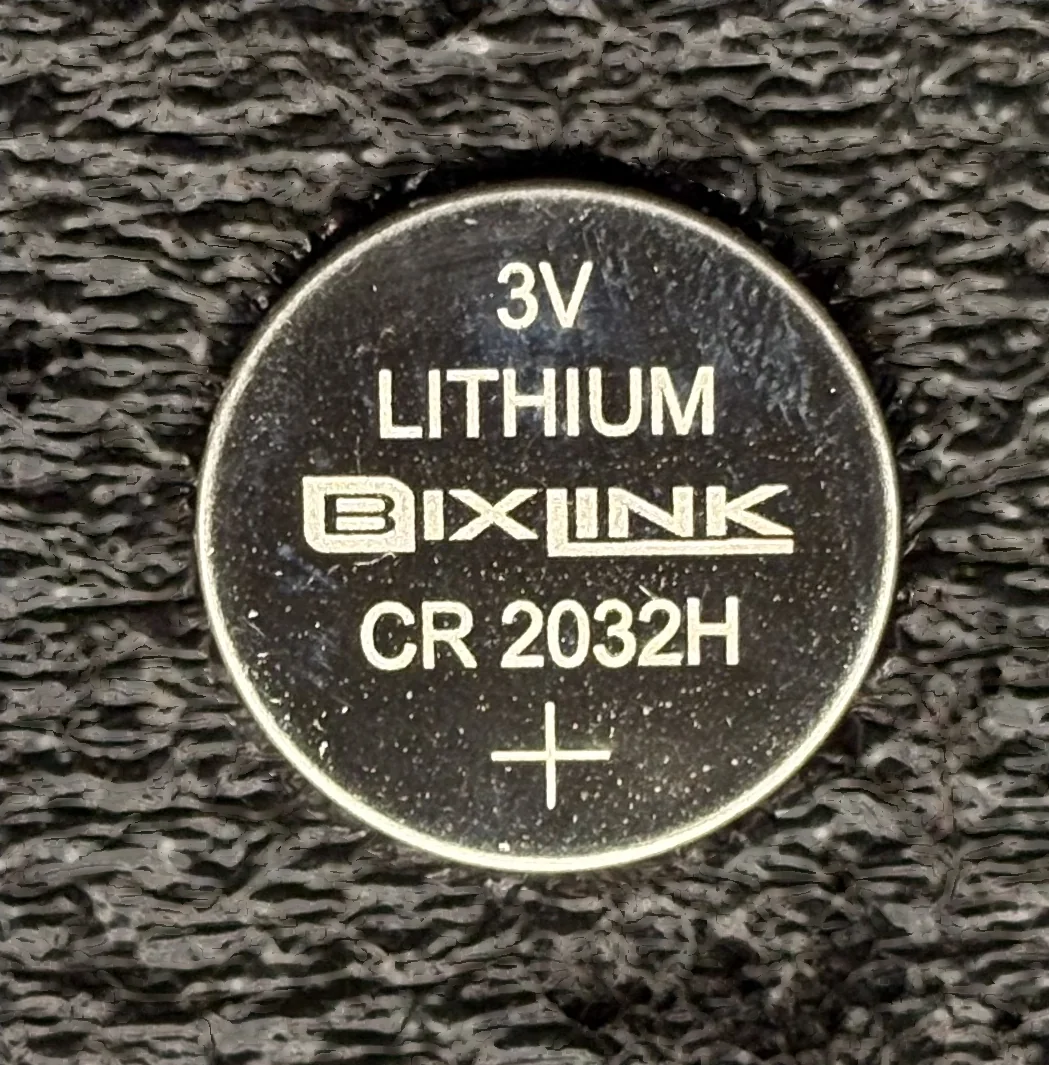 CR2032H coin cell, held in hand