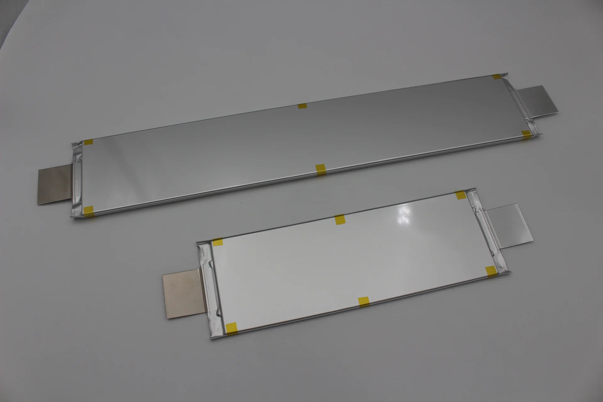Two solid-state lithium ceramic cells: long flat laminate pouches with foil tabs